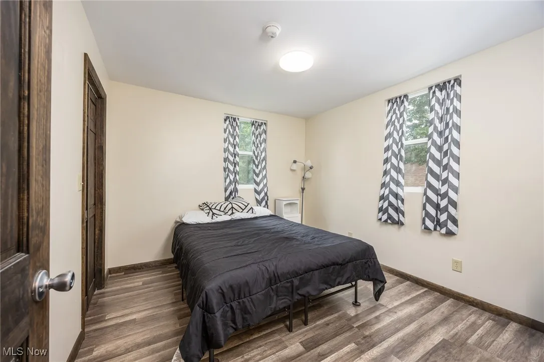 Bedroom featuring multiple windows and wood finished floors