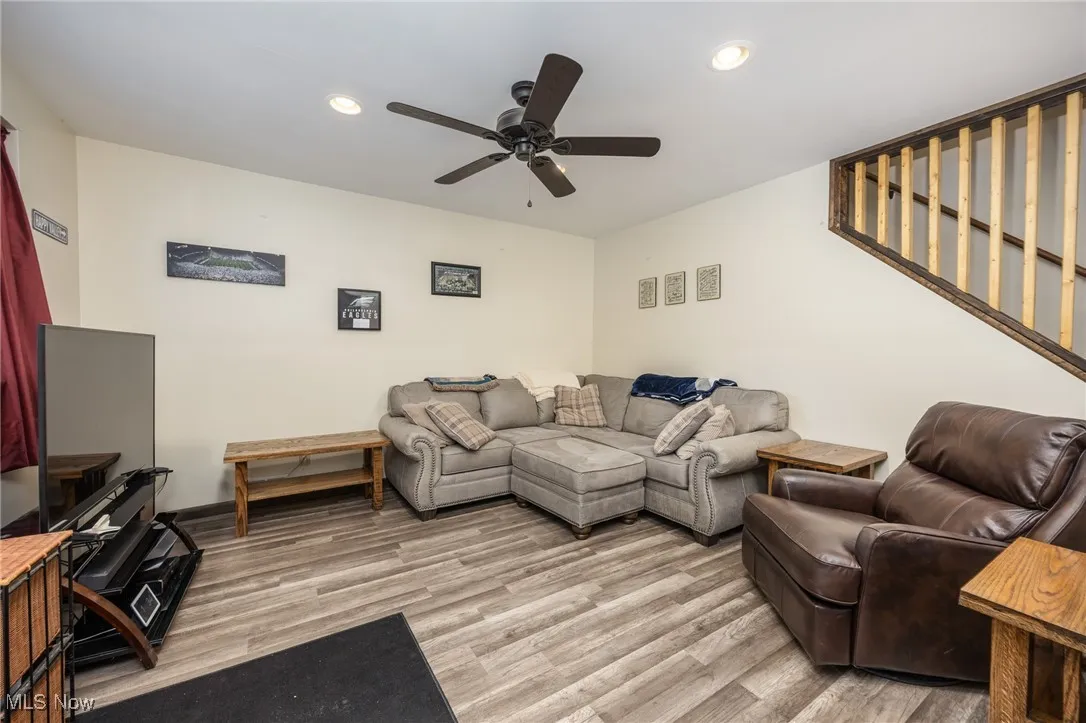 Living room featuring ceiling fan, light wood-style floors, and recessed lighting