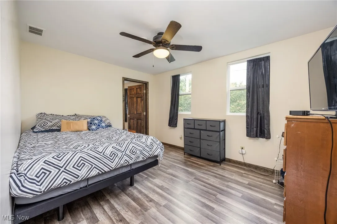 Bedroom with wood finished floors and a ceiling fan
