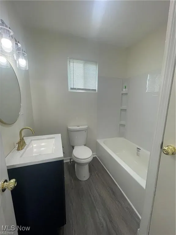 Bathroom featuring vanity and wood finished floors