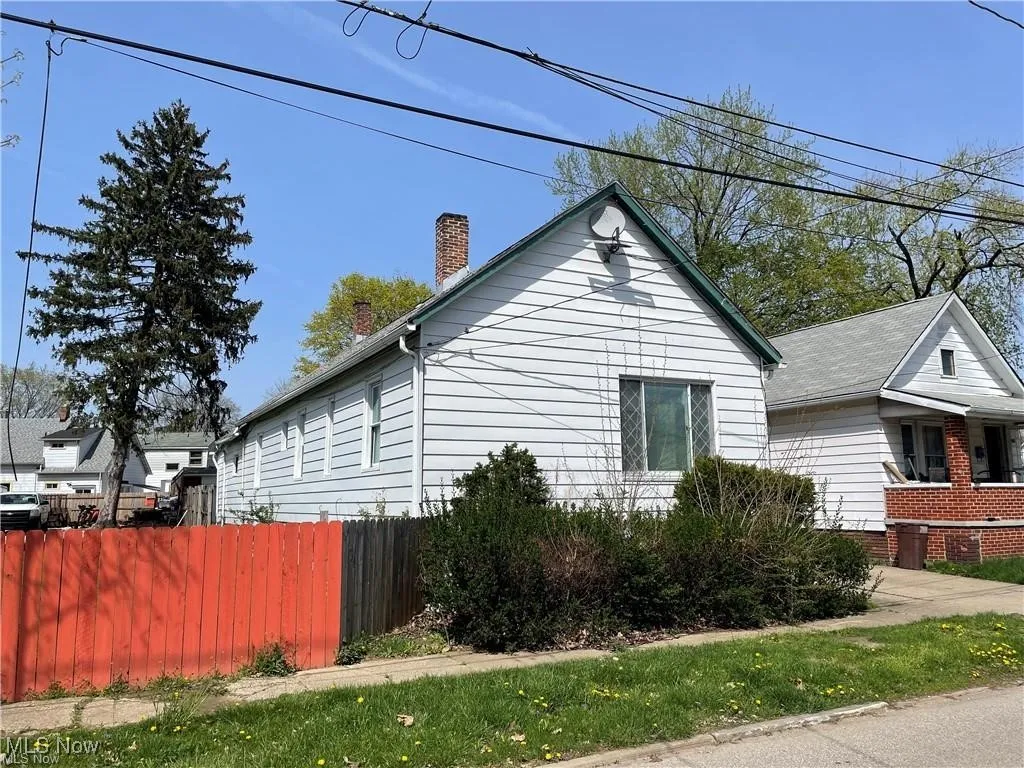 View of side of home with a chimney