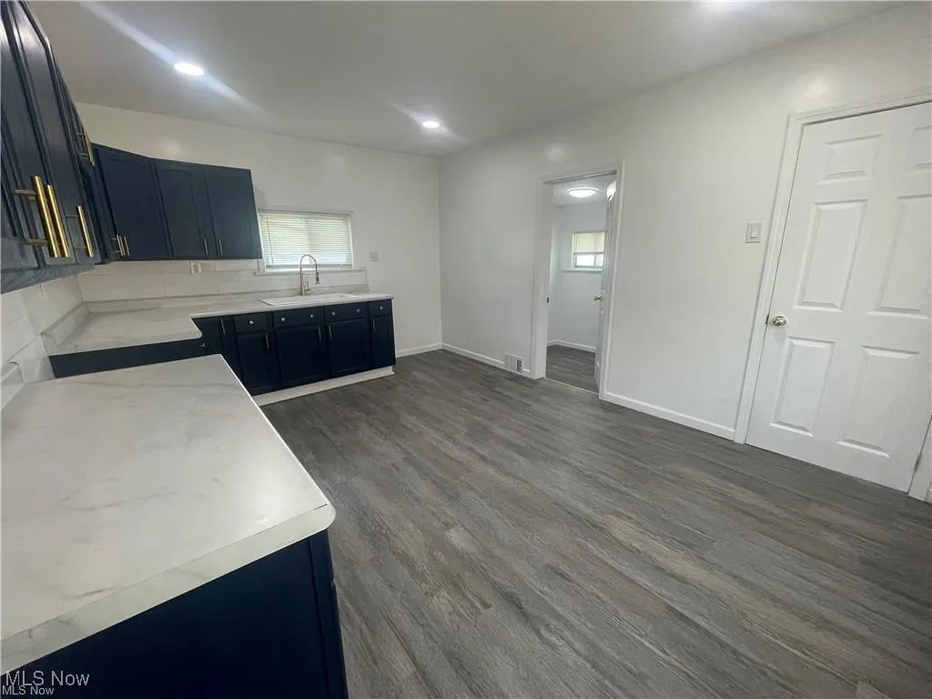 Kitchen with dark wood finished floors and recessed lighting