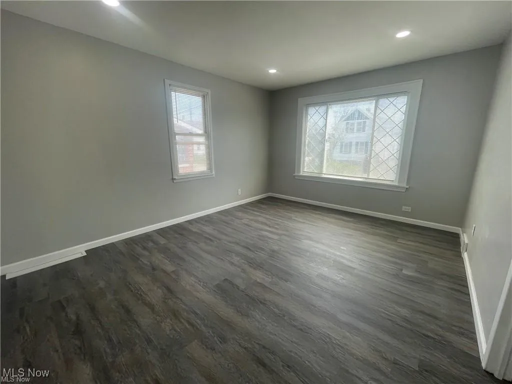 Spare room featuring dark wood-style flooring and recessed lighting