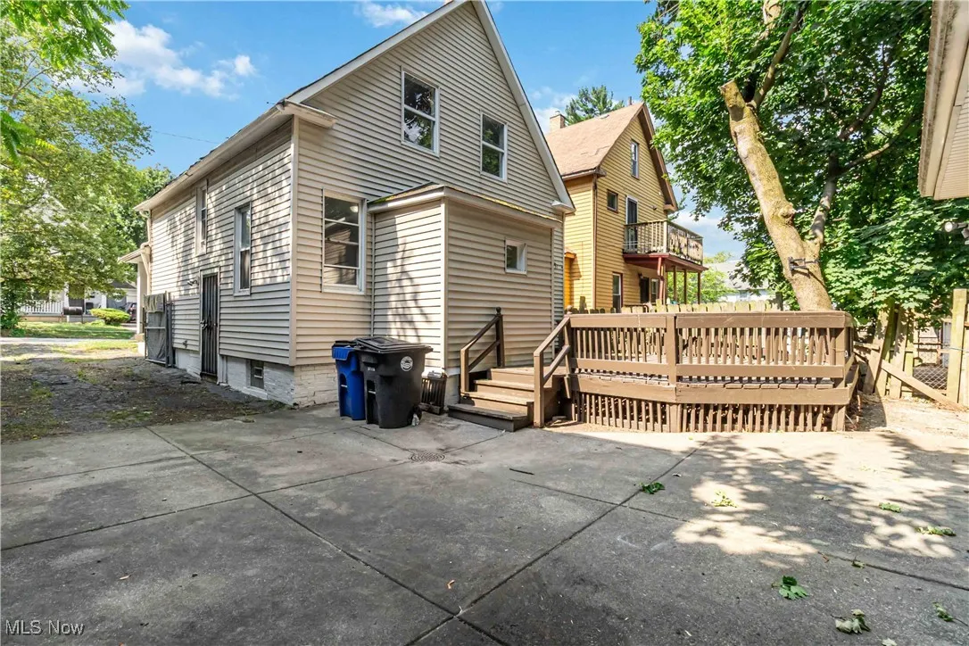 Rear view of property featuring a deck and a patio area
