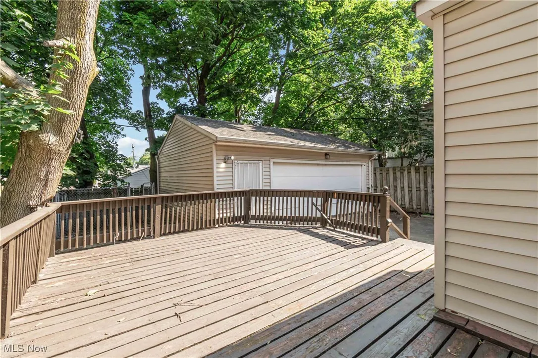 Wooden terrace featuring an outbuilding
