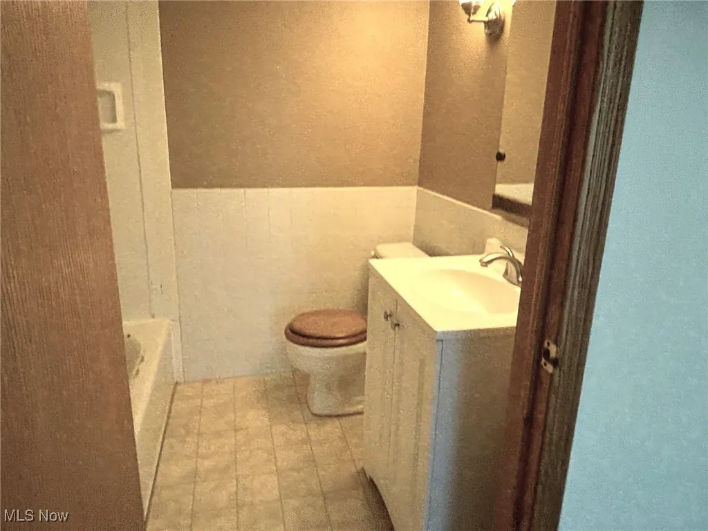 Master Bathroom with vanity, a bath, and a wainscoted wall on 2nd floor