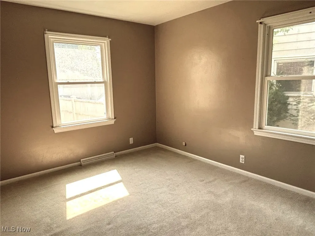 Bed on 1st floor Empty room featuring carpet flooring and baseboards