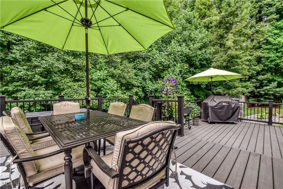 Wooden terrace with a grill and outdoor dining space