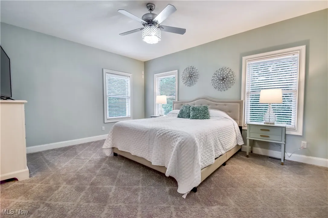 Bedroom with carpet floors and a ceiling fan