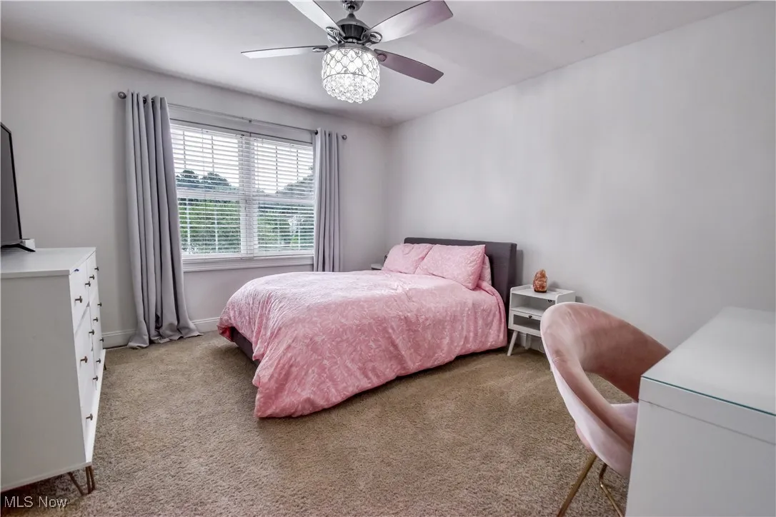 Bedroom featuring carpet and ceiling fan
