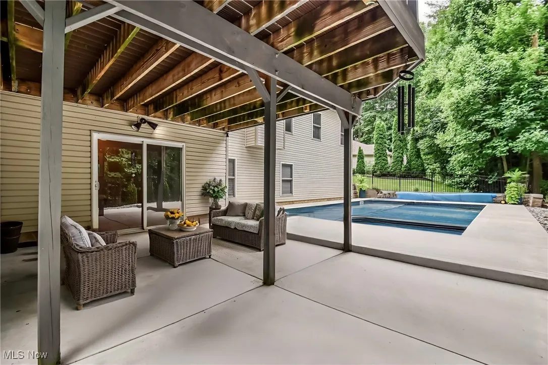 View of patio featuring an outdoor hangout area and a covered pool