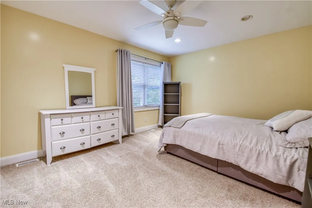 Bedroom featuring light colored carpet, recessed lighting, and ceiling fan