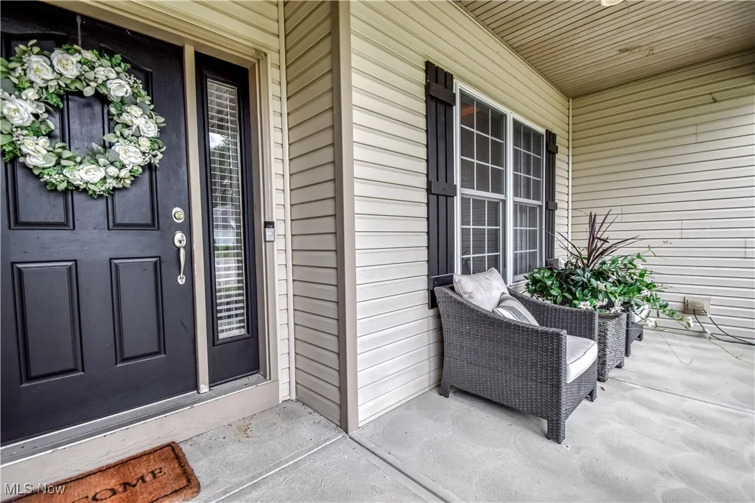 View of exterior entry featuring covered porch
