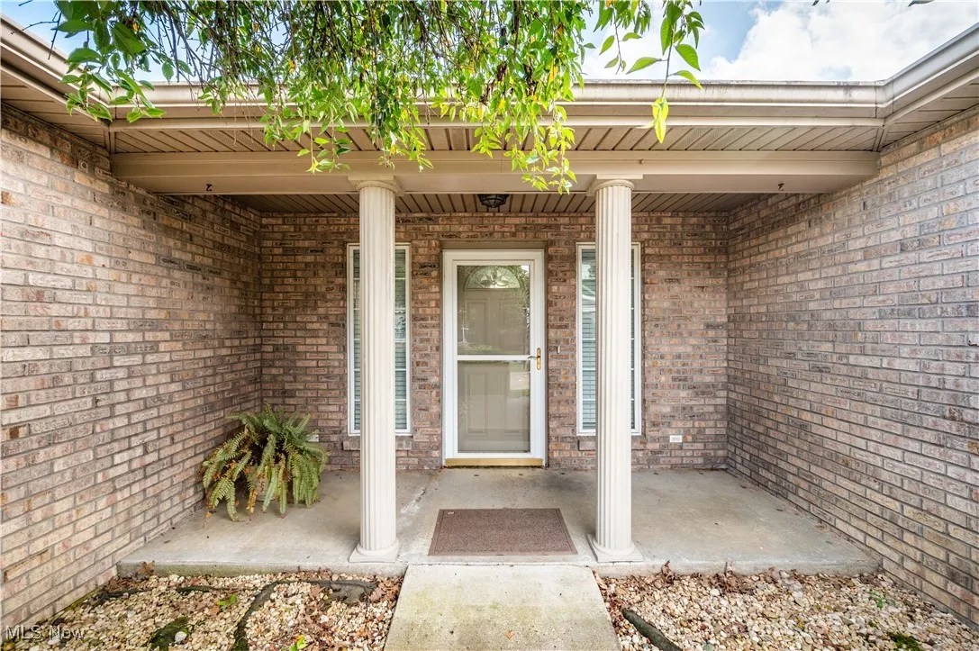 Doorway to property featuring brick siding