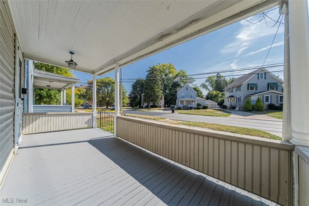 Wooden porch featuring a residential view