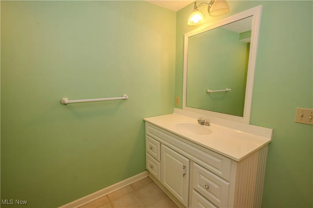 Bathroom with vanity and tile patterned flooring