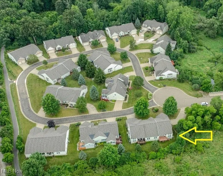 Aerial view of property's location with nearby suburban area