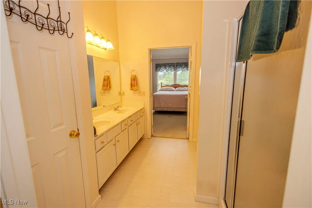 Ensuite bathroom with double vanity and a shower stall