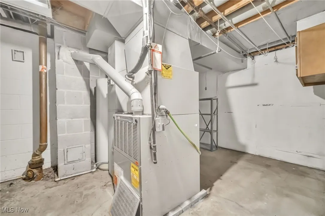Utility room featuring heating unit