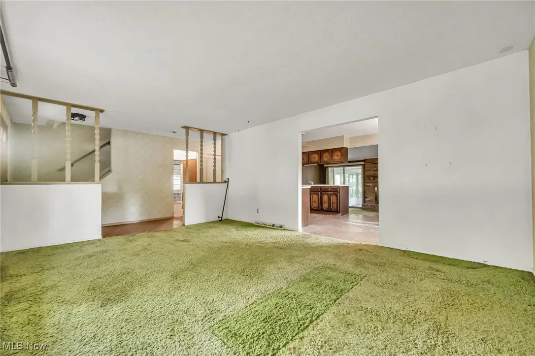 Unfurnished living room featuring carpet floors