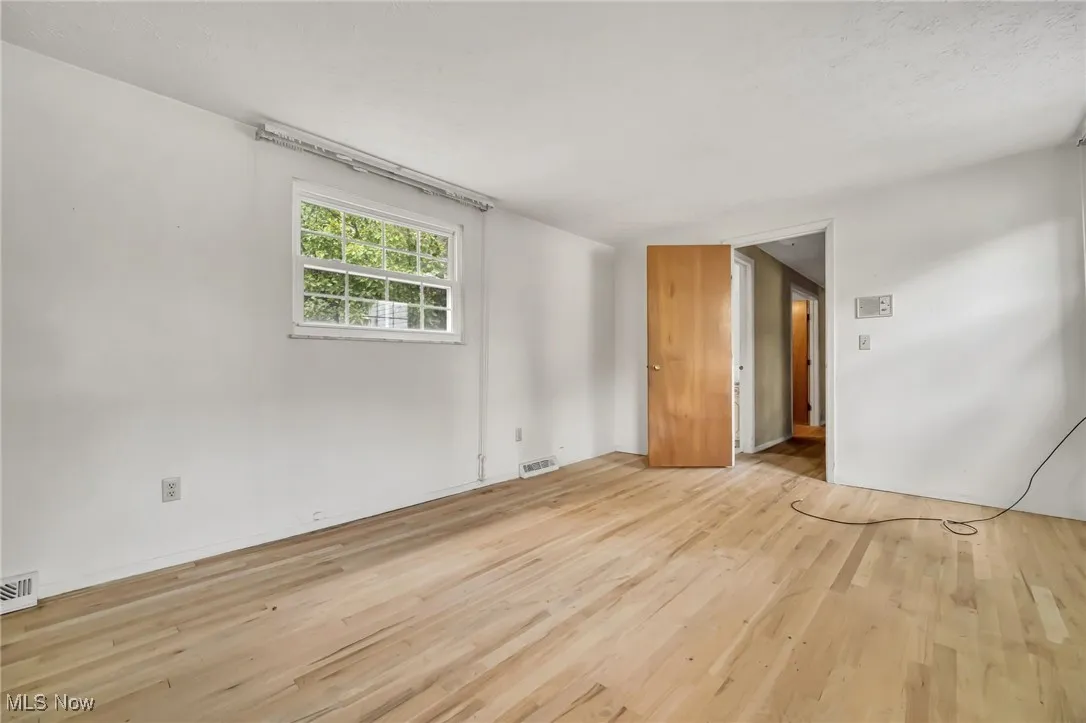 Empty room featuring wood finished floors