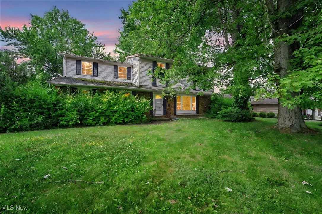 Traditional-style home featuring a lawn