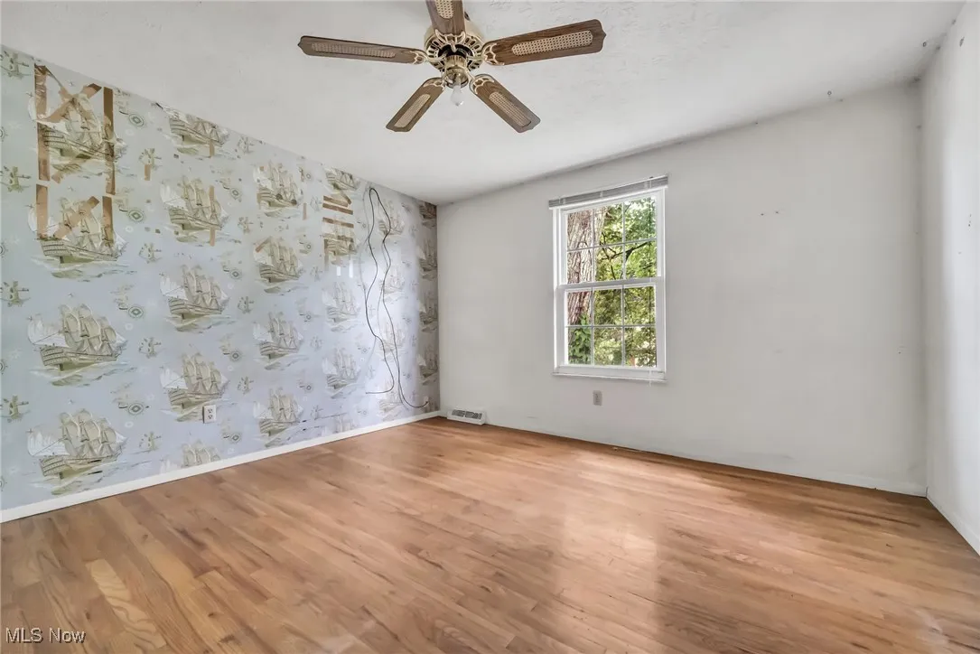 Spare room featuring ceiling fan and light wood finished floors
