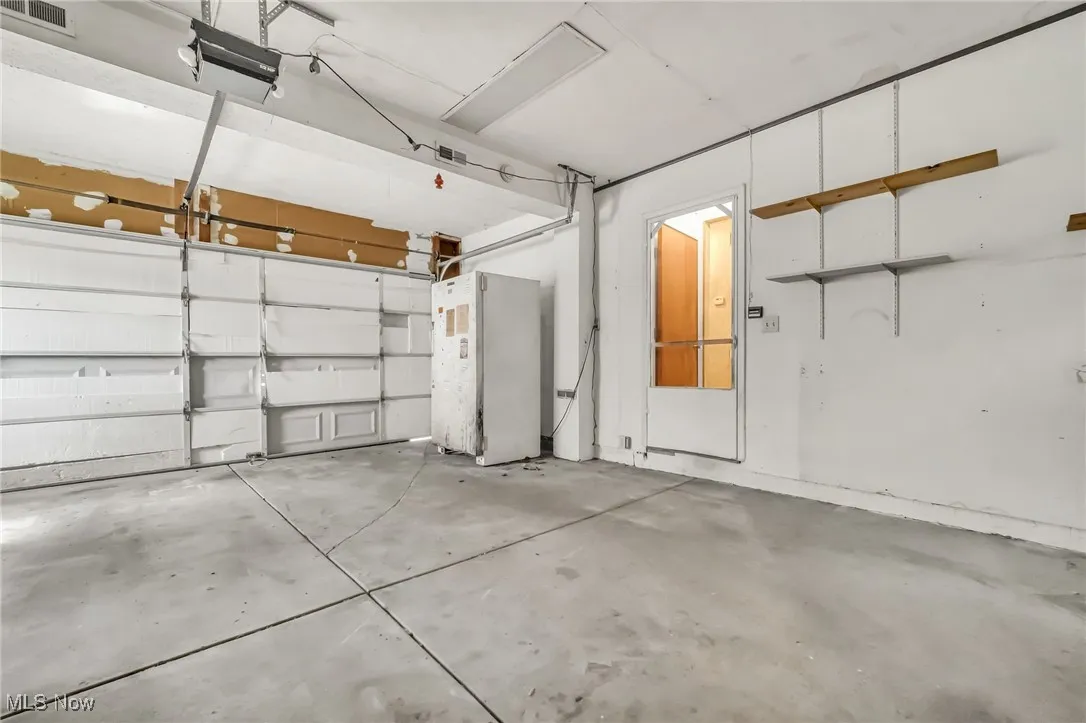 Garage featuring freestanding refrigerator
