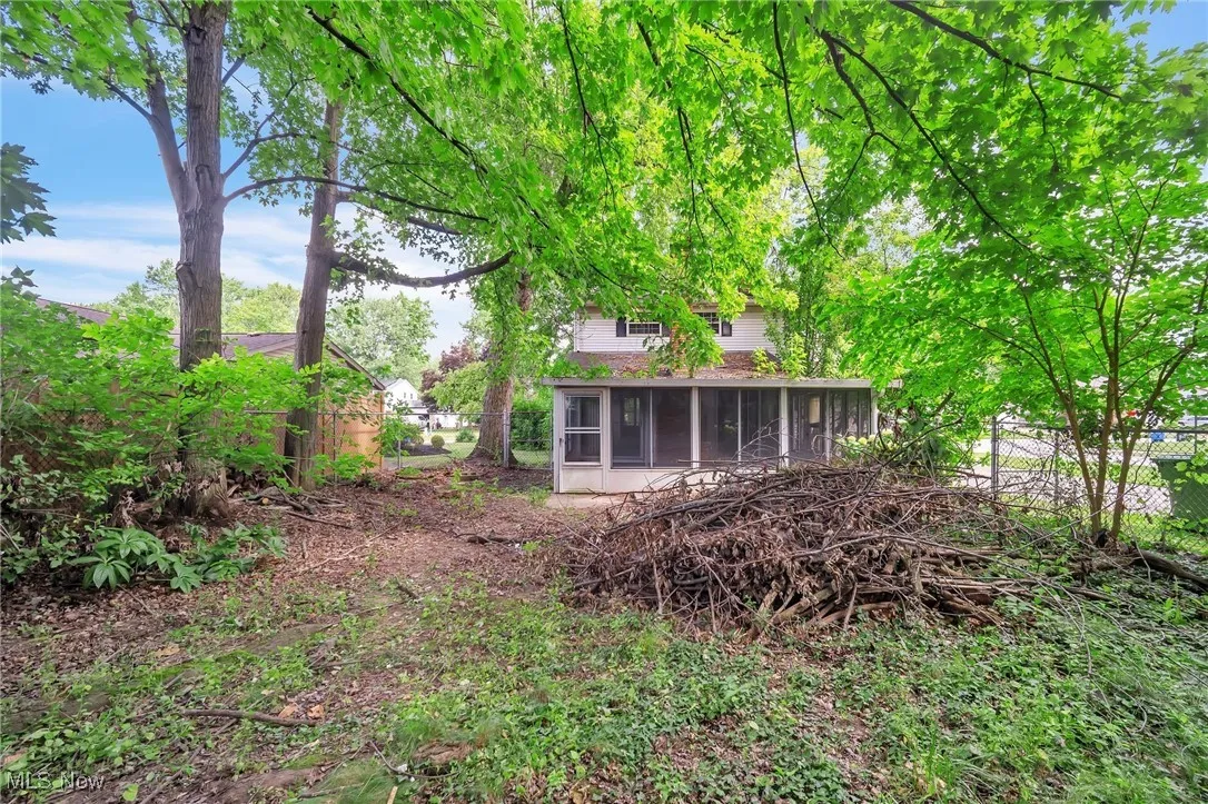 Rear view of house with a sunroom
