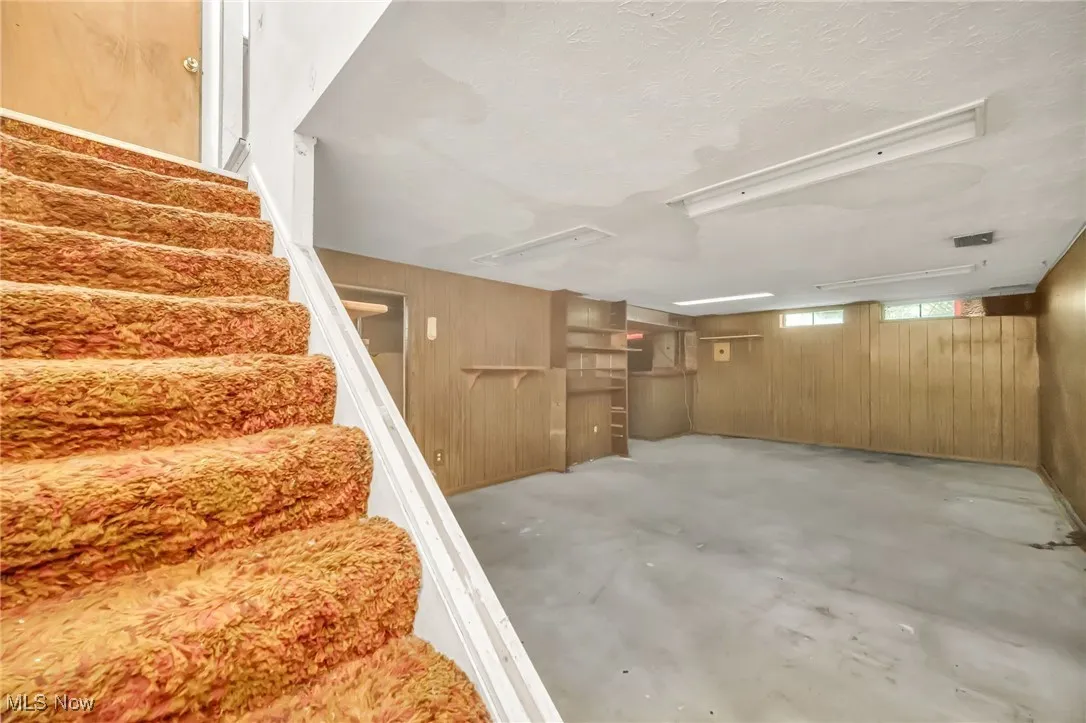 Basement with wooden walls and stairway