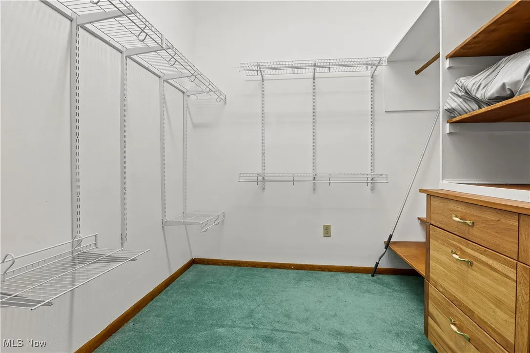 Spacious walk in closet featuring built ins off the Master Suite