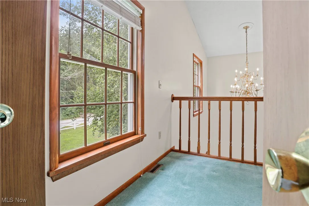 Room overlooking Foyer featuring carpet floors, healthy amount of natural light, vaulted ceiling, with an entrance off the Master Bedroom.