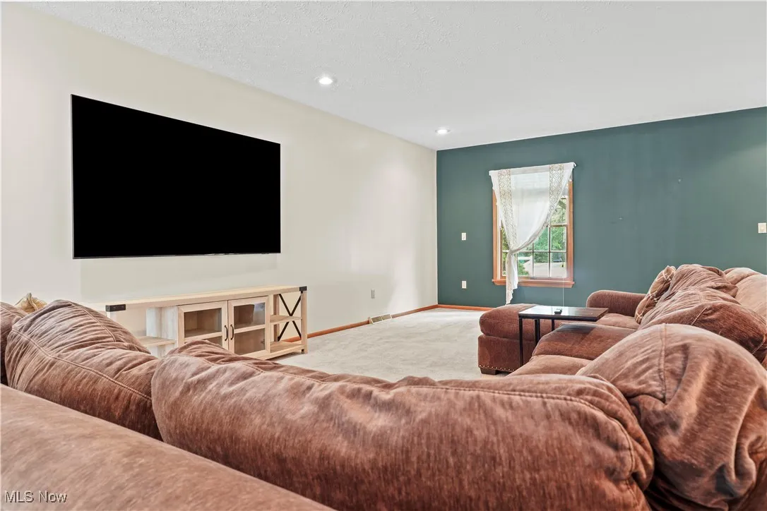 Living area with carpet and recessed lighting