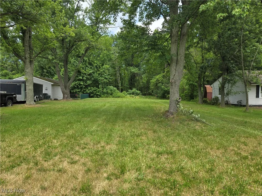 View of green lawn featuring an outdoor structure