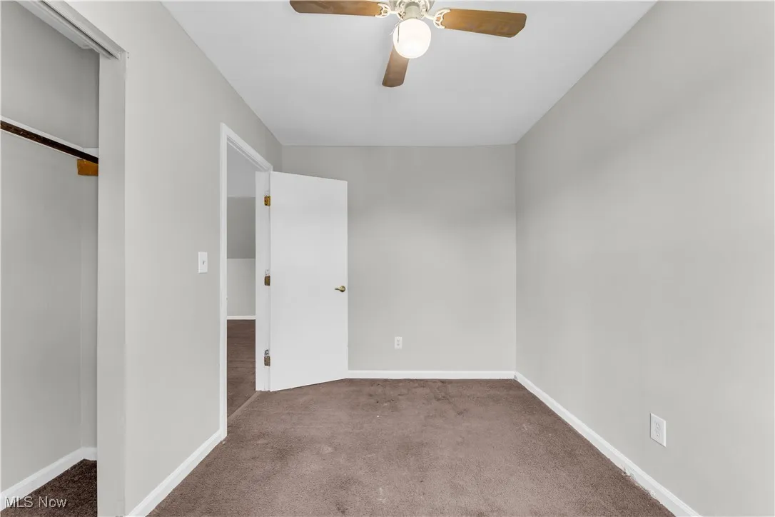 Unfurnished bedroom featuring carpet floors, a closet, and ceiling fan
