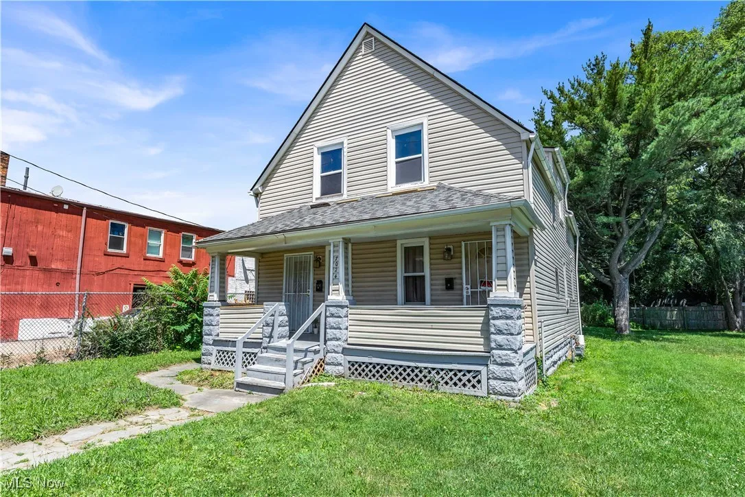 View of front of property with a porch and roof with shingles