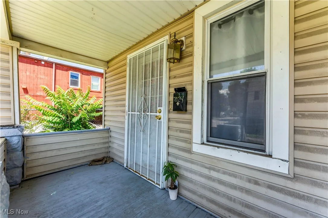 Doorway to property featuring a porch