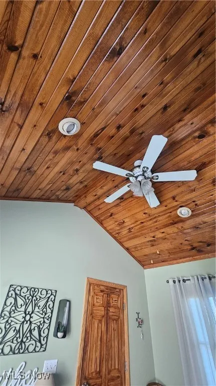 Detailed view of wood ceiling, a ceiling fan, and recessed lighting
