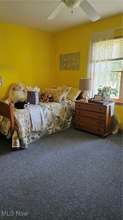 Bedroom with carpet flooring and a ceiling fan