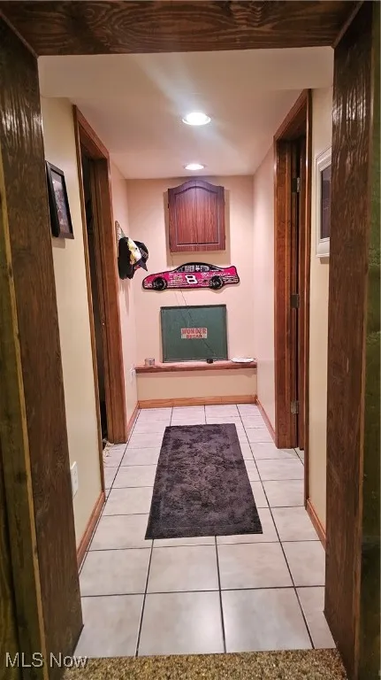 Hall featuring recessed lighting and light tile patterned flooring