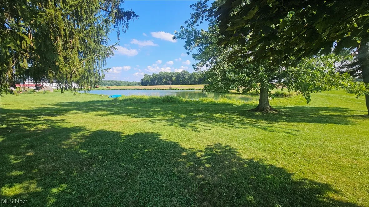 View of grassy yard with a water view