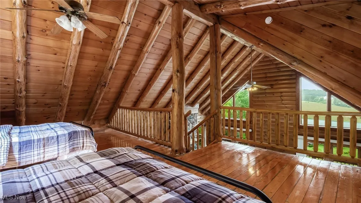 Unfurnished bedroom featuring hardwood / wood-style floors, wood ceiling, and multiple windows