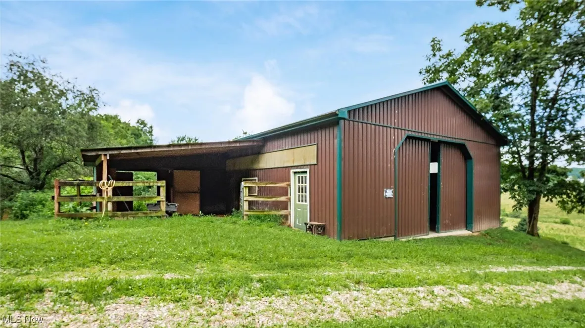 View of pole building with a yard