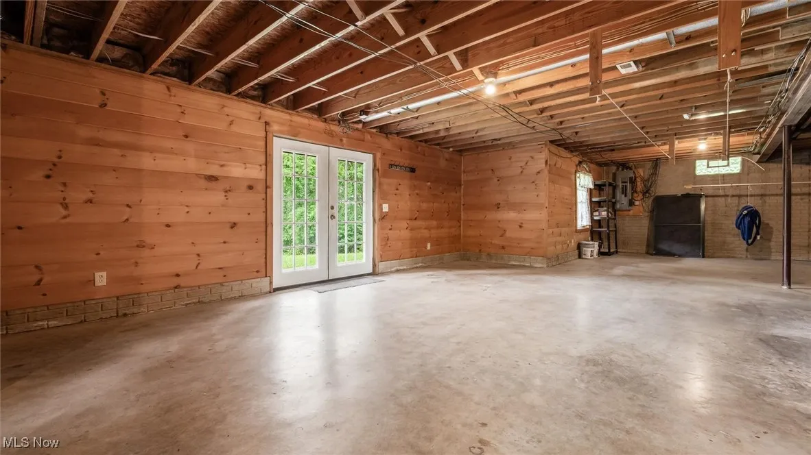 Below grade area featuring wood walls