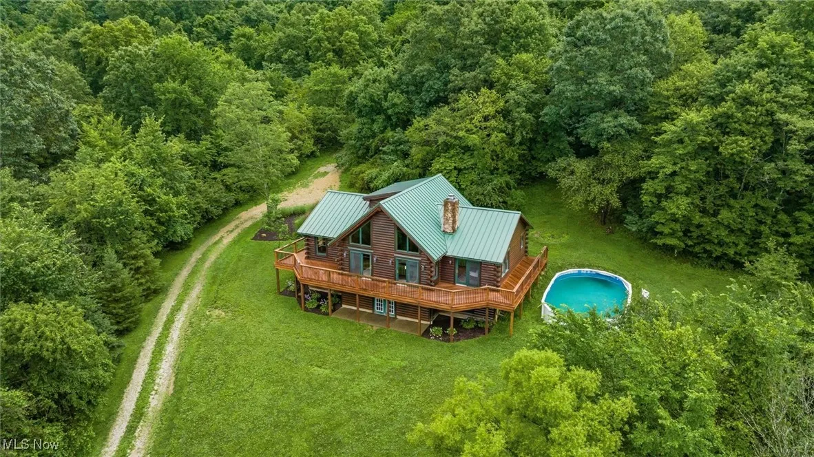 View of subject property featuring a heavily wooded area
