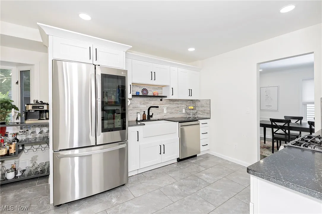 This image showcases yet another perspective of the expansive and exquisitely designed gourmet kitchen, highlighting its impressive features and ample space.