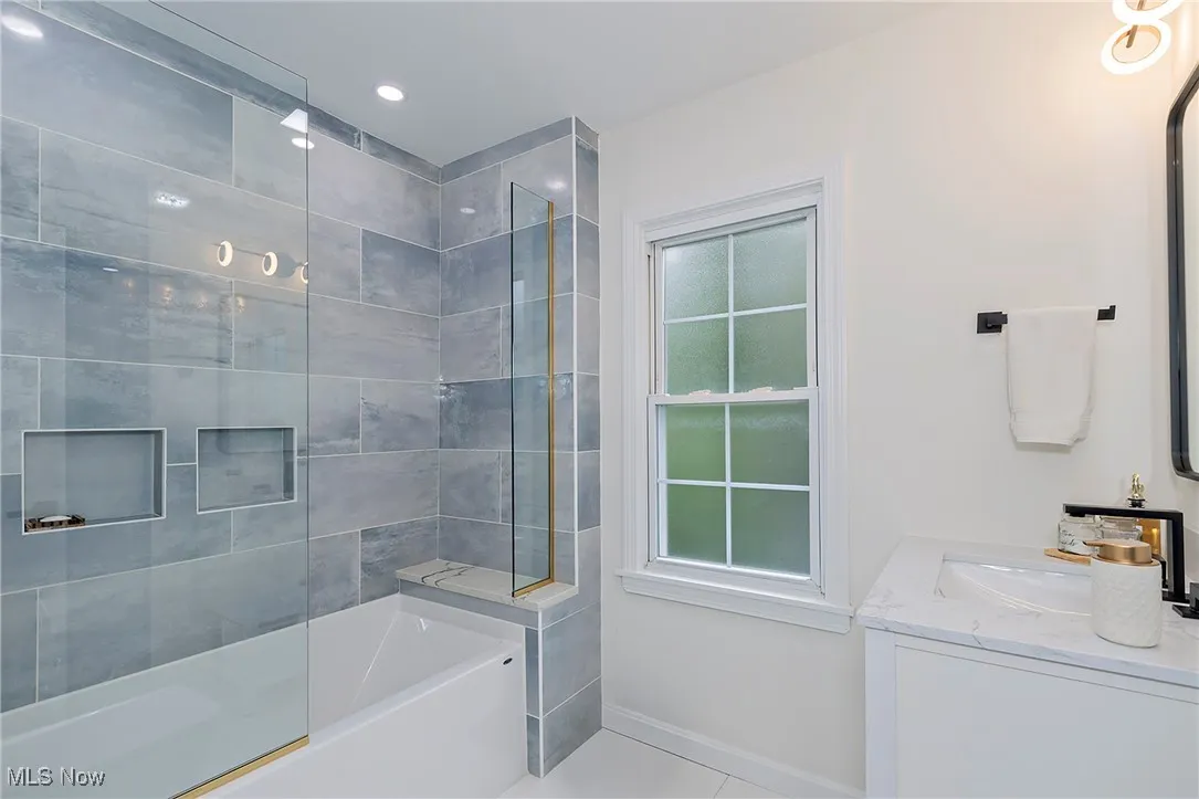 This full bath with custom finishes and clean lines offers a spa-like relaxation experience.