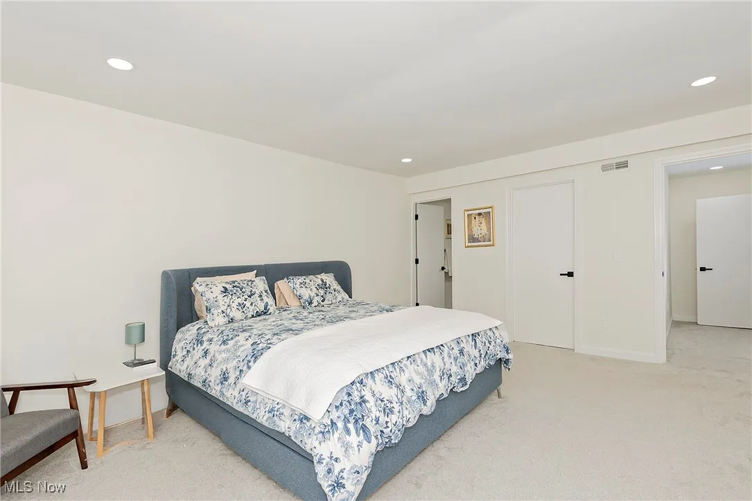 The oversized primary suite is set apart by a separate hallway and features walk-in closets and a spa-like bathroom.