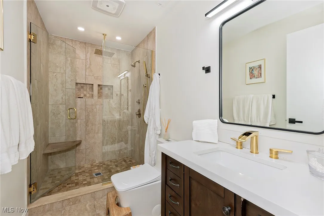 Custom, calm primary suite bathroom with spa-like features and ample storage.