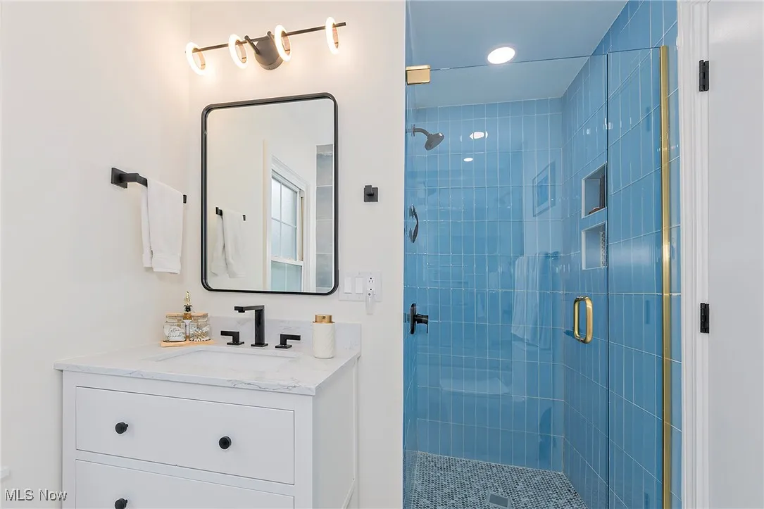 Lovely vertical tile in the walk-in shower is a nice feature not to be missed. The modern design and easy access make this shower a standout!